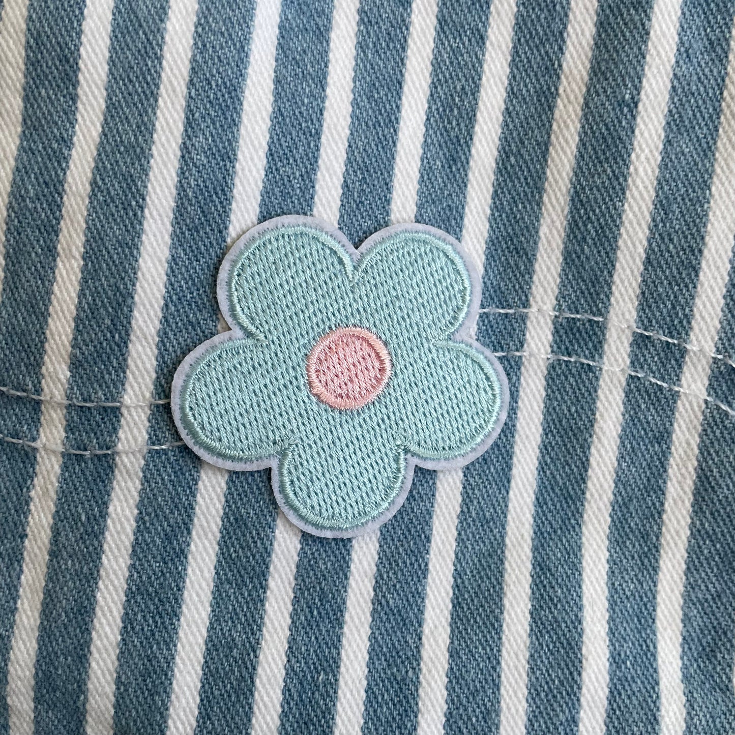 Upcycled striped denim mini skirt with flowers and face pocket